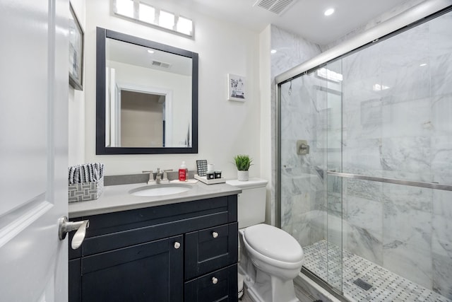 bathroom featuring vanity, toilet, and walk in shower