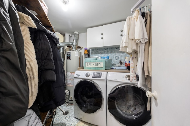 laundry room featuring cabinets, separate washer and dryer, and water heater