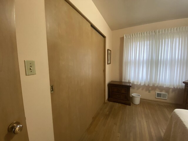 unfurnished bedroom featuring light hardwood / wood-style floors and a closet