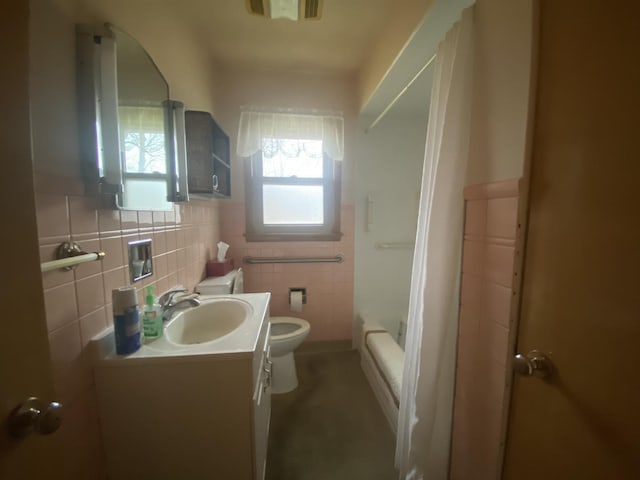 full bathroom with vanity, shower / washtub combination, tile walls, and toilet