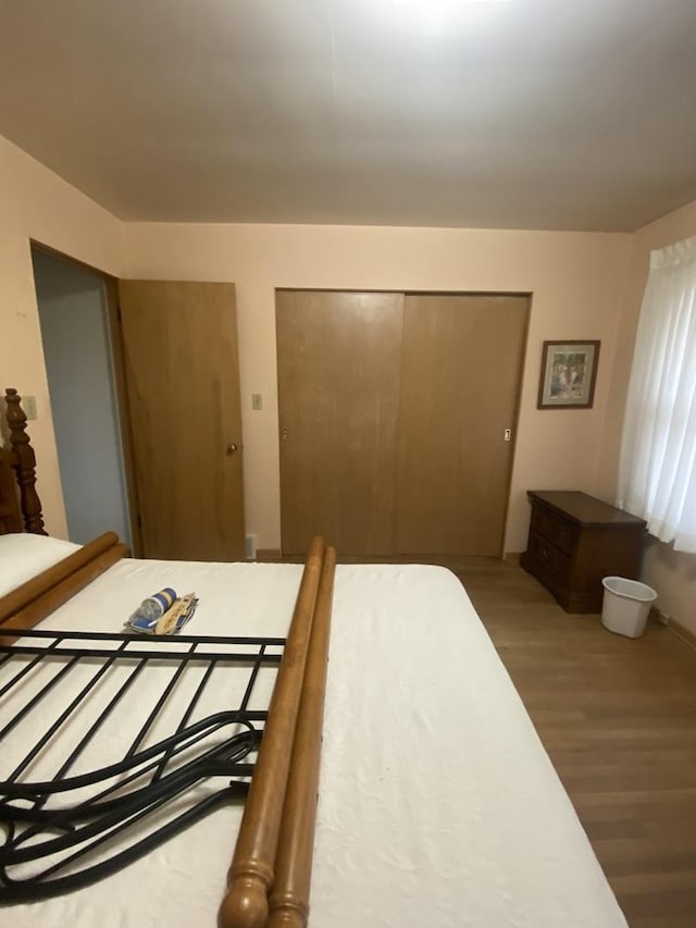 bedroom featuring hardwood / wood-style floors and a closet