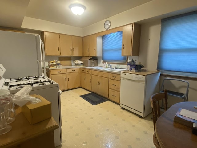 kitchen featuring white appliances, sink, and light brown cabinets