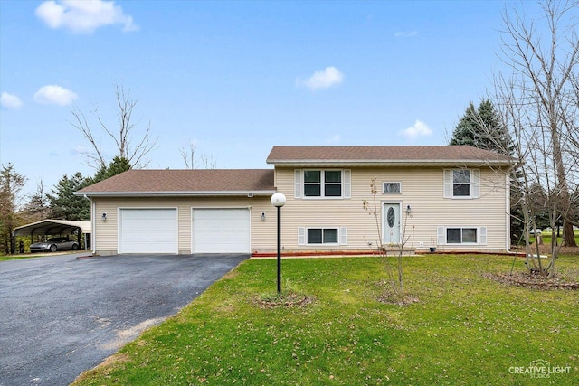 bi-level home featuring a garage, a carport, and a front yard