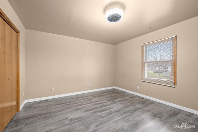 unfurnished bedroom with hardwood / wood-style floors and a closet