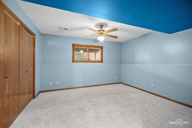 unfurnished bedroom featuring ceiling fan, carpet, and a closet