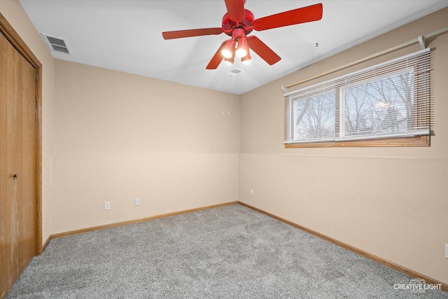 unfurnished bedroom featuring ceiling fan, carpet flooring, and a closet