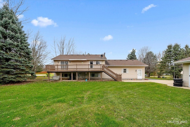 rear view of property with a yard and a deck