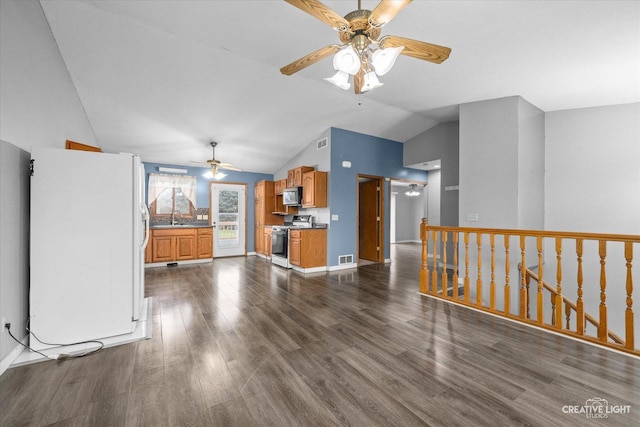 unfurnished living room with sink, vaulted ceiling, dark hardwood / wood-style floors, and ceiling fan