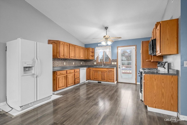 kitchen with white appliances, dark hardwood / wood-style flooring, sink, and decorative backsplash