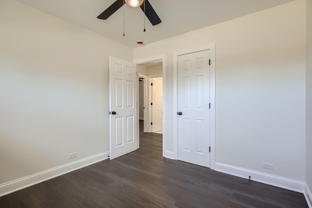 unfurnished bedroom with ceiling fan and dark hardwood / wood-style floors