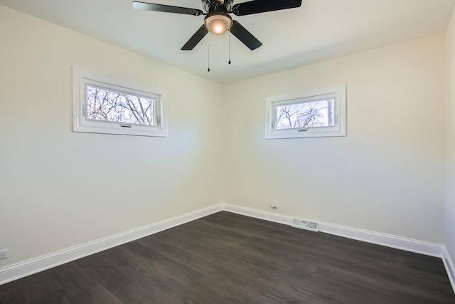 unfurnished room featuring dark hardwood / wood-style flooring, ceiling fan, and a healthy amount of sunlight