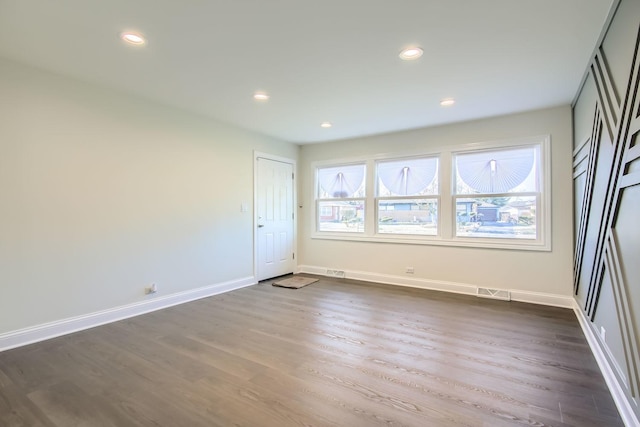 spare room featuring dark hardwood / wood-style floors