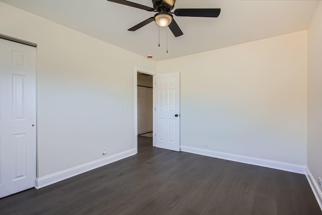 unfurnished bedroom with dark wood-type flooring and ceiling fan