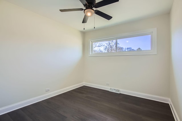 empty room featuring dark hardwood / wood-style flooring and ceiling fan