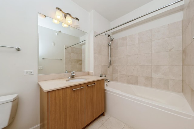 full bathroom featuring vanity, tiled shower / bath, tile patterned floors, and toilet