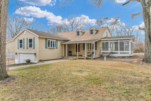 view of front of house with a garage, a front yard, a sunroom, and covered porch