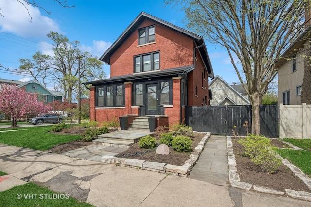 2645 Prairie Ave, Evanston, IL 60201 - view of front facade with concrete driveway, brick siding, and fence