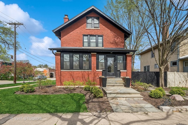 2645 Prairie Ave, Evanston, IL 60201 - traditional style home featuring brick siding, a chimney, and fence
