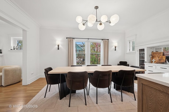 2645 Prairie Ave, Evanston, IL 60201 - dining room featuring light wood-type flooring, baseboards, a chandelier, and crown molding