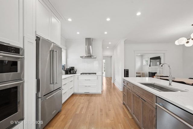 2645 Prairie Ave, Evanston, IL 60201 - kitchen featuring a sink, stainless steel appliances, crown molding, wall chimney range hood, and recessed lighting