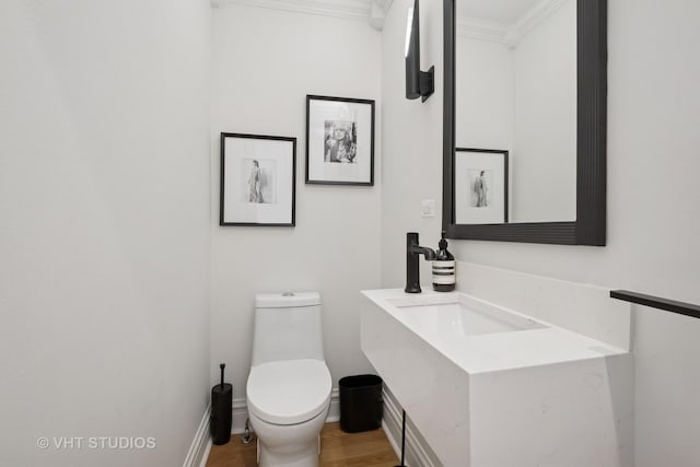 2645 Prairie Ave, Evanston, IL 60201 - bathroom featuring toilet, wood finished floors, baseboards, vanity, and ornamental molding
