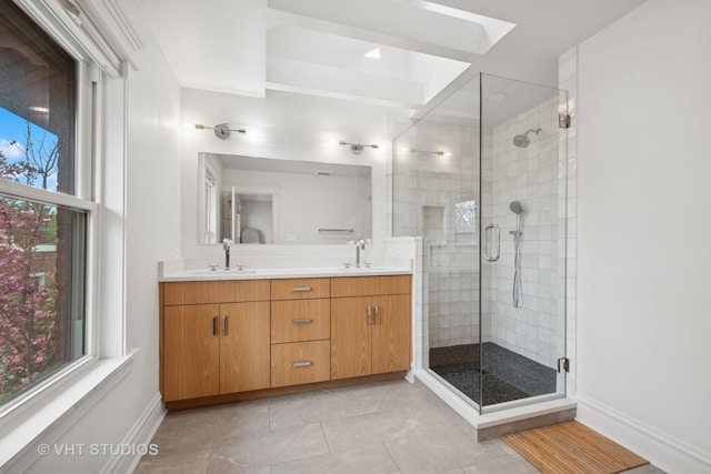 2645 Prairie Ave, Evanston, IL 60201 - full bath featuring double vanity, a stall shower, a sink, tile patterned floors, and baseboards
