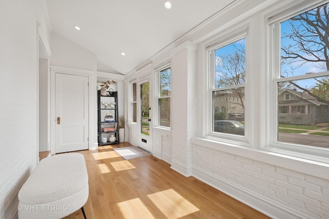 2645 Prairie Ave, Evanston, IL 60201 - interior space with recessed lighting, light wood-style floors, vaulted ceiling, and brick wall