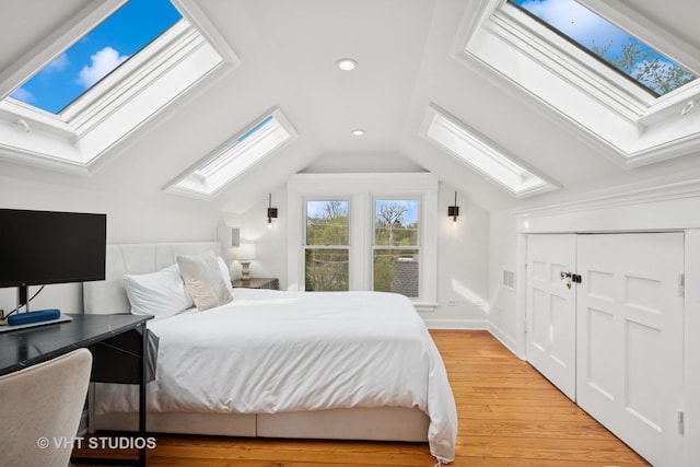 2645 Prairie Ave, Evanston, IL 60201 - bedroom with light wood-style floors, a closet, recessed lighting, and vaulted ceiling with skylight