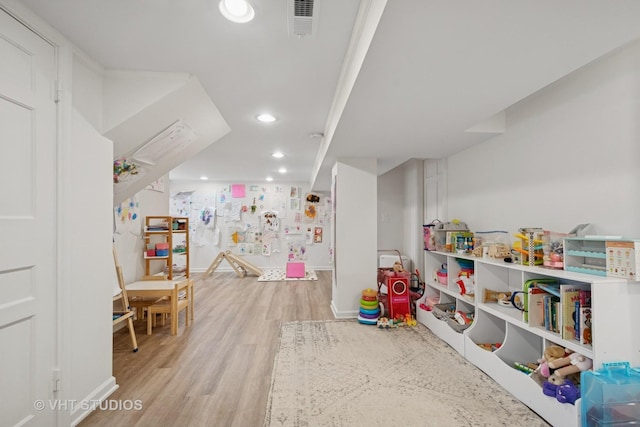 2645 Prairie Ave, Evanston, IL 60201 - rec room featuring light wood finished floors, visible vents, and recessed lighting