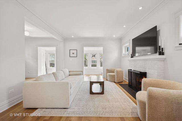 2645 Prairie Ave, Evanston, IL 60201 - living area featuring wood finished floors, a fireplace, baseboards, and a healthy amount of sunlight
