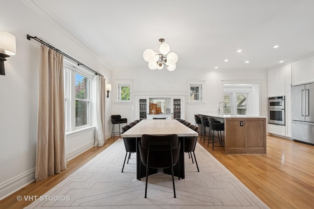 2645 Prairie Ave, Evanston, IL 60201 - dining room featuring light wood-type flooring, a chandelier, ornamental molding, and recessed lighting