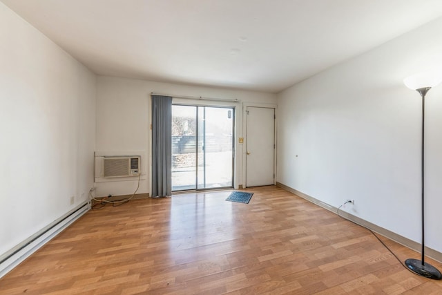 unfurnished living room with a baseboard radiator, baseboards, light wood-style flooring, and a wall mounted AC