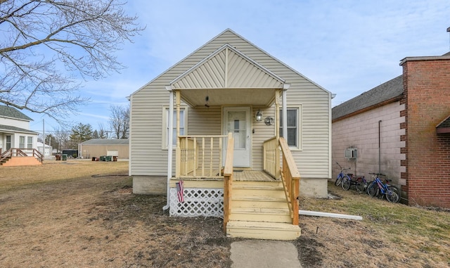 bungalow-style house with a wall unit AC