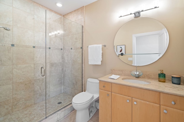 bathroom featuring vanity, an enclosed shower, tile patterned floors, and toilet