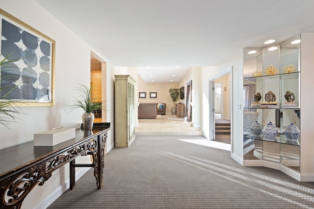 hallway with carpet floors