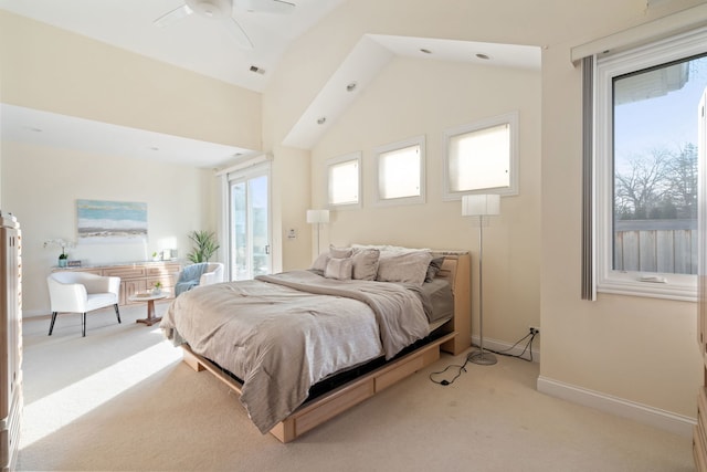 bedroom featuring access to exterior, vaulted ceiling, light colored carpet, and ceiling fan