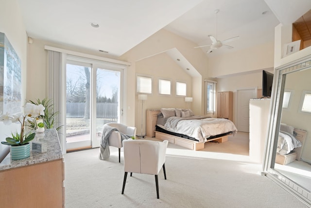 bedroom with multiple windows, vaulted ceiling, light carpet, and access to outside