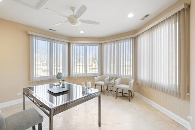 sunroom / solarium featuring ceiling fan