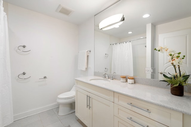 bathroom with vanity, tile patterned floors, and toilet