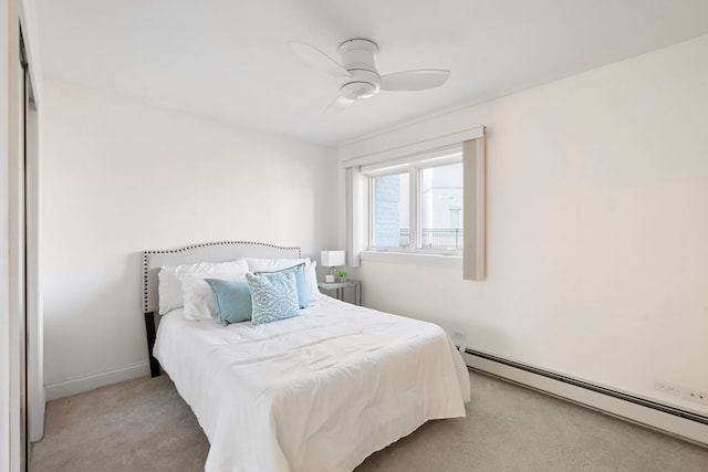 carpeted bedroom with ceiling fan and a baseboard radiator