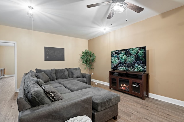 living room with hardwood / wood-style floors and ceiling fan