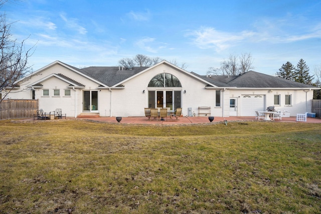 back of property featuring a yard and a patio