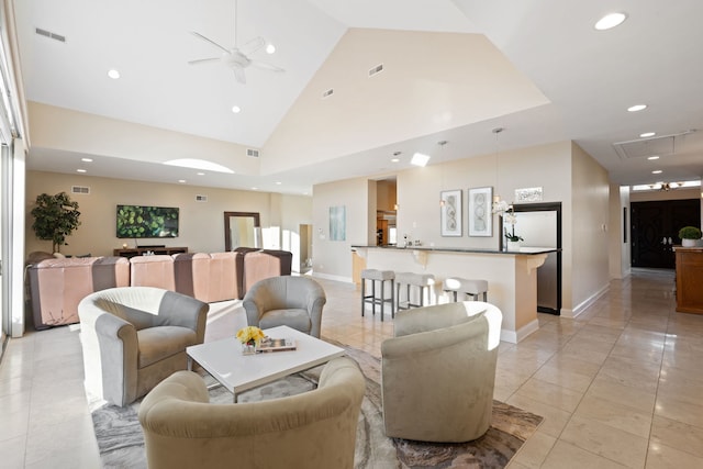 living room featuring ceiling fan, light tile patterned floors, and high vaulted ceiling