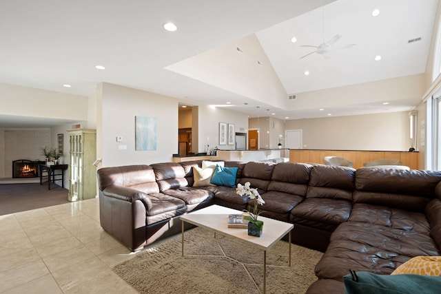 living room featuring a fireplace and high vaulted ceiling