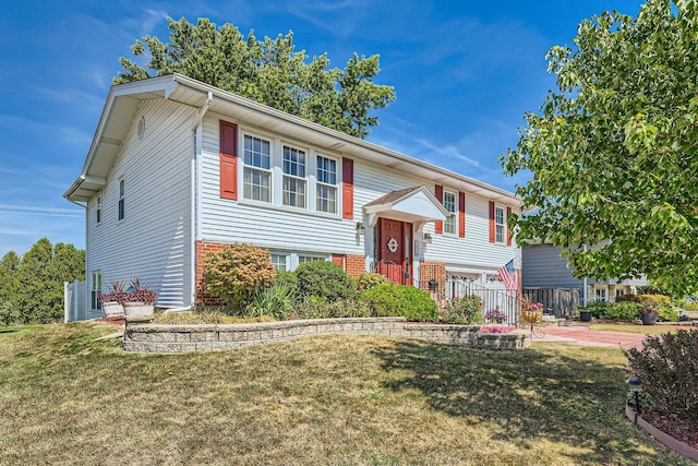 bi-level home with a garage and a front yard