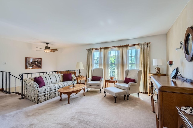 carpeted living room with ceiling fan