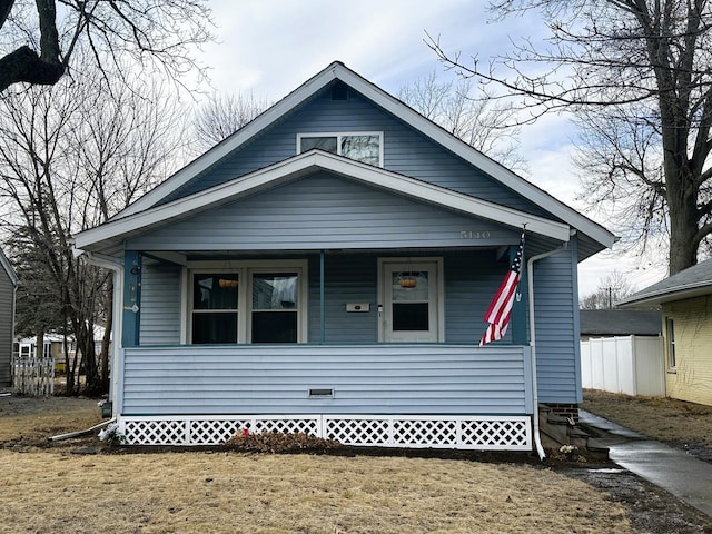 bungalow-style home featuring a porch and a front lawn