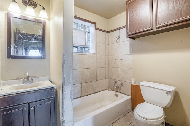 full bathroom with vanity, tiled shower / bath, tile patterned floors, and toilet