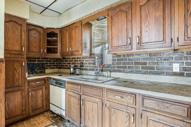 kitchen with sink, dark parquet flooring, dishwasher, and backsplash