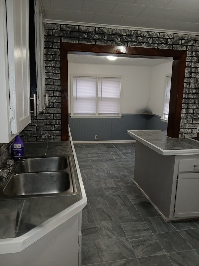 kitchen with white cabinetry and sink